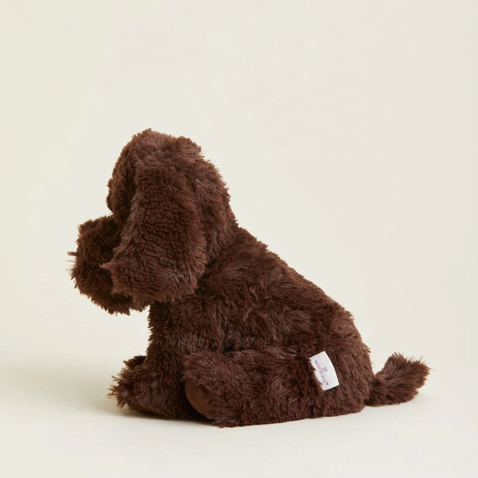 Fluffy brown stuffed dog toy sitting sideways.