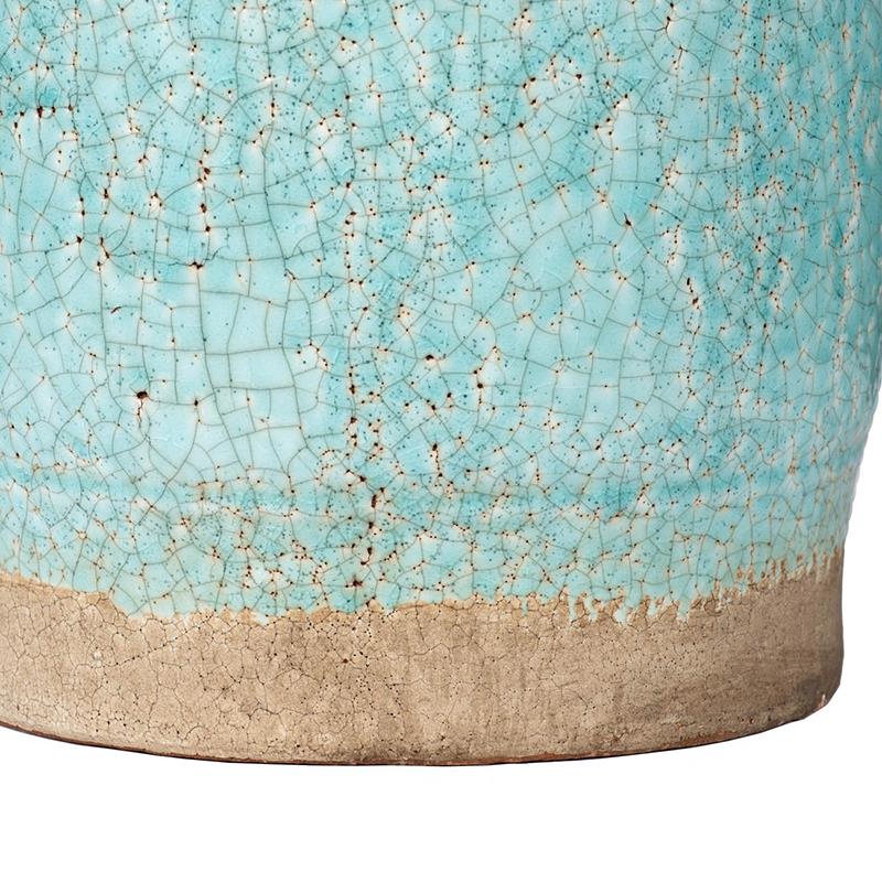 Turquoise ceramic with a crackle glaze and earthy, textured base.