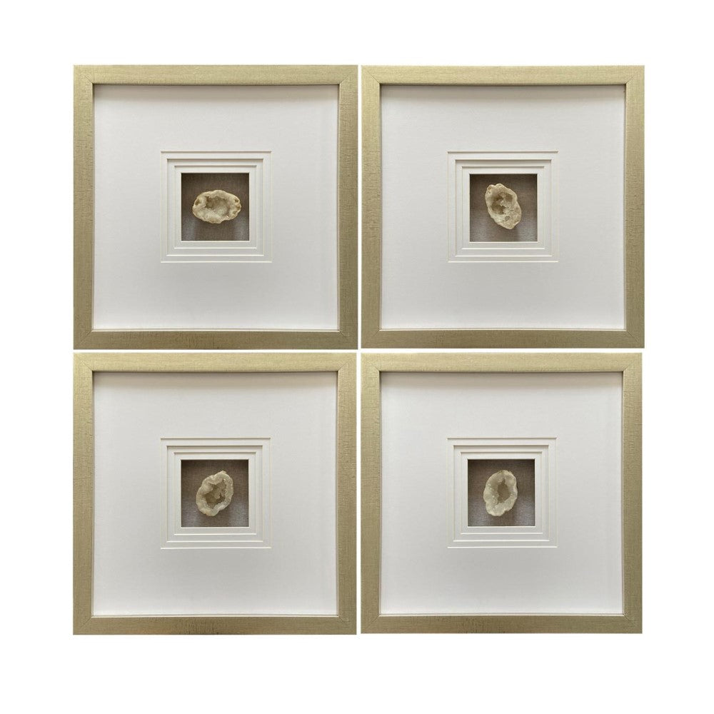 Four framed geodes in square, gold-colored frames.