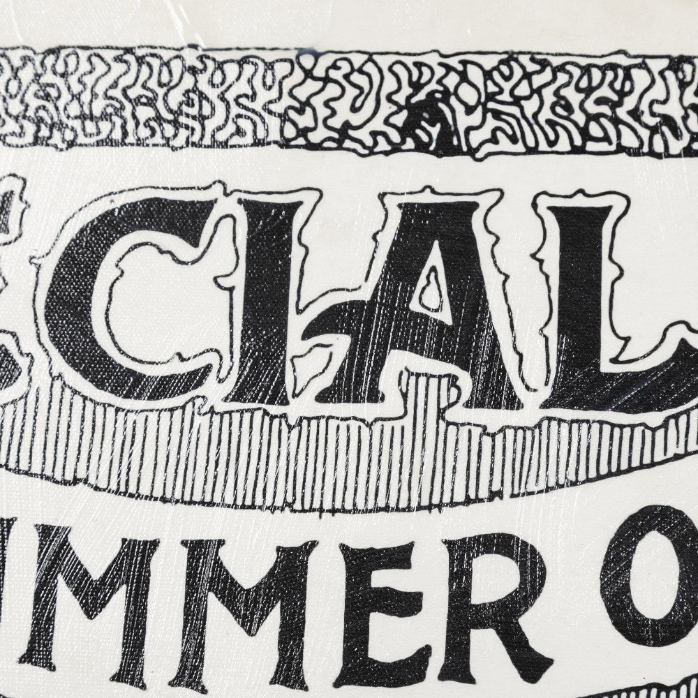 Close-up of vintage text art with intricate black patterns.