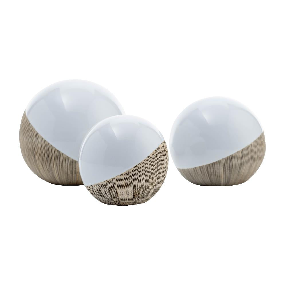 Three glossy, half-textured spheres with white tops and brown bases.