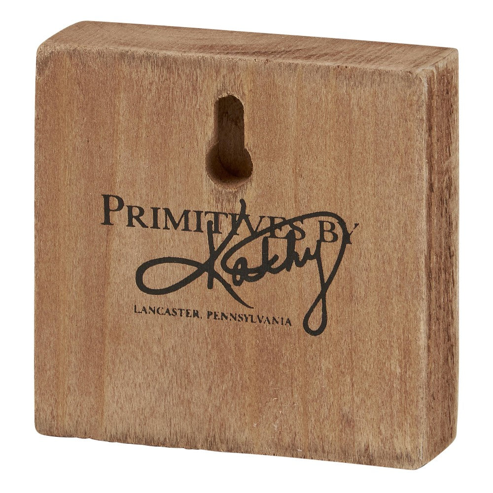 Wooden block with "Primitives by Kathy" and a keyhole on the back.