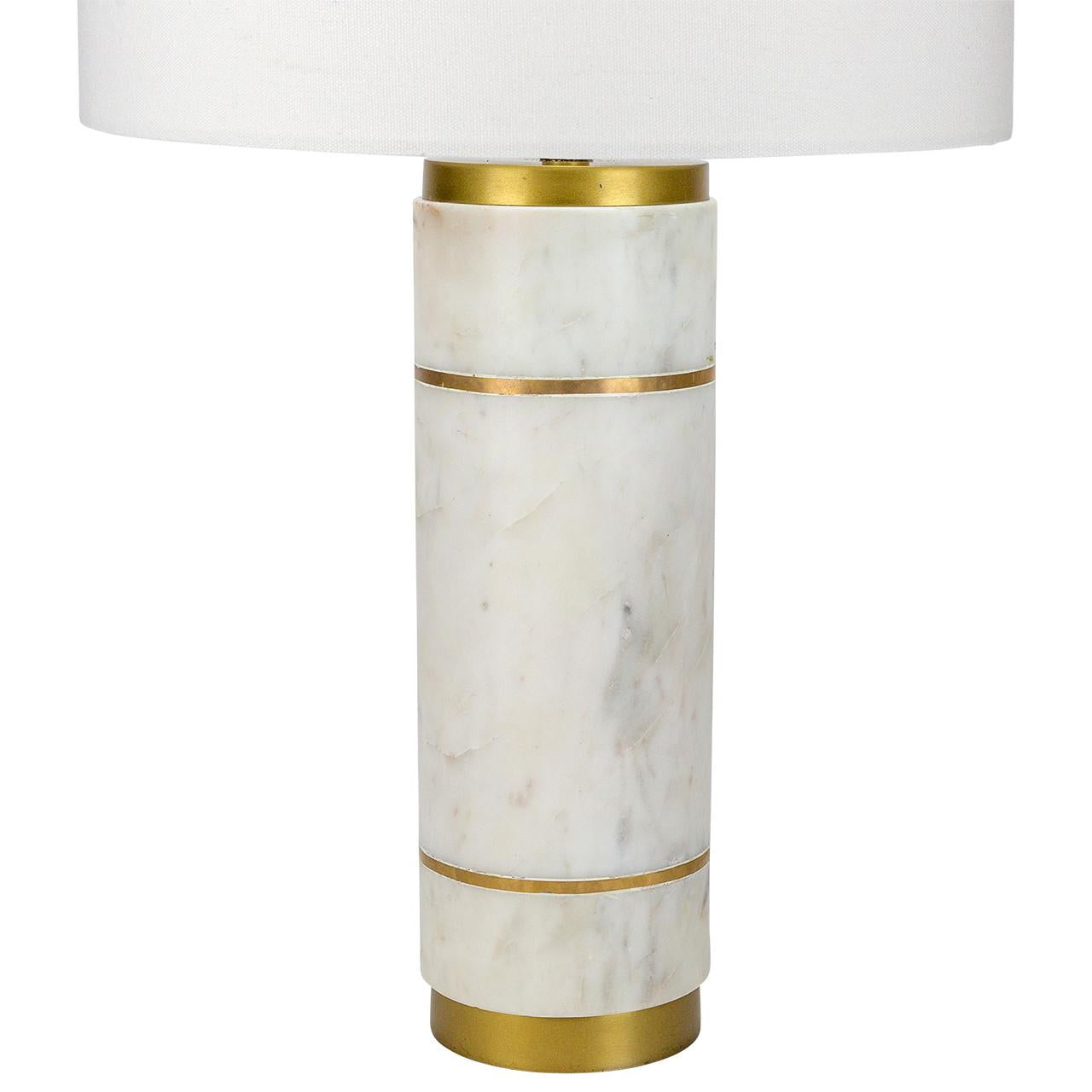 Marble lamp with gold accents and white shade.