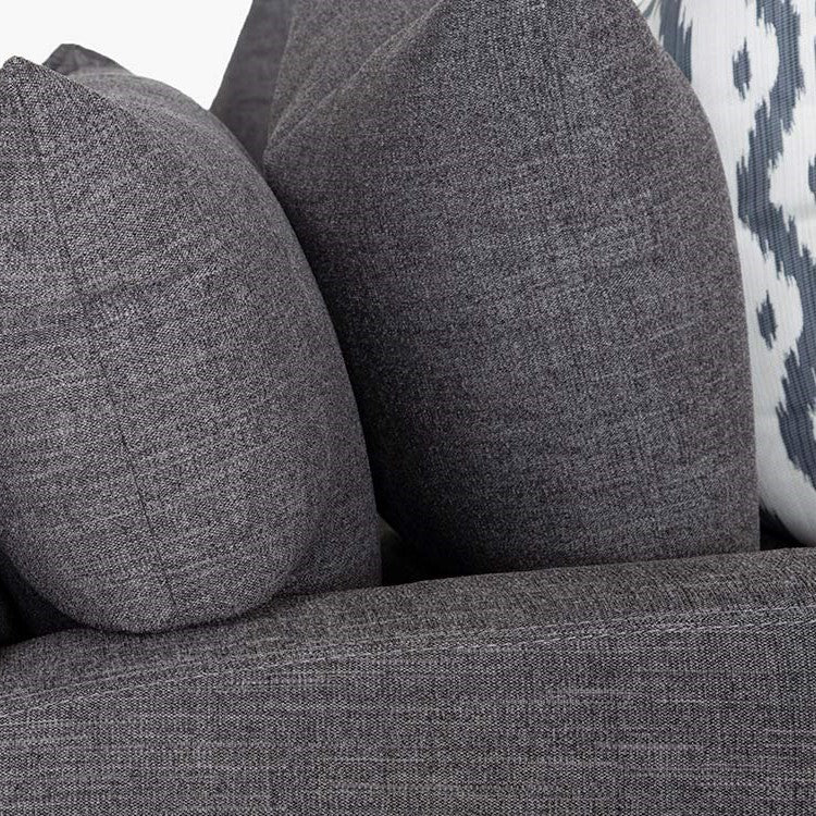 Gray textured cushions with a patterned background.