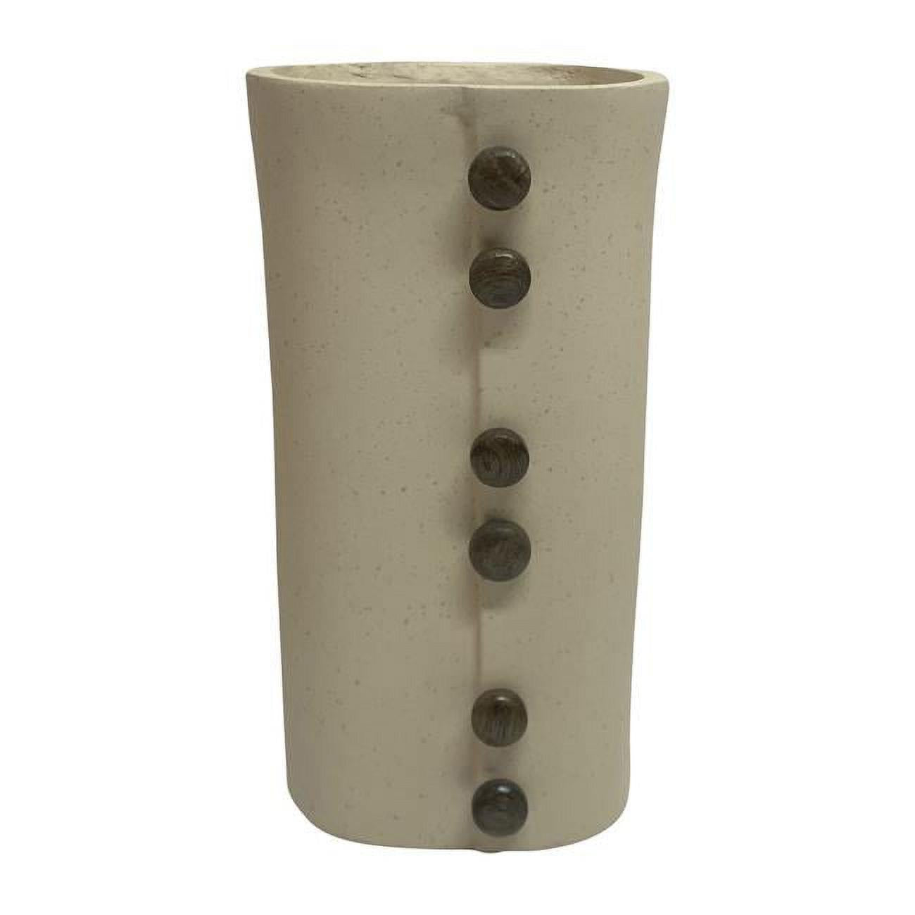 Tall beige vase with vertical black buttons.