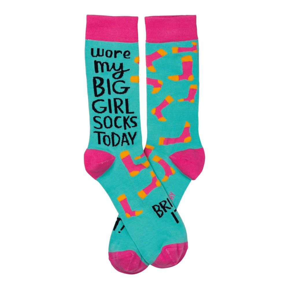 Teal socks with pink heels, playful text, and colorful sock patterns.