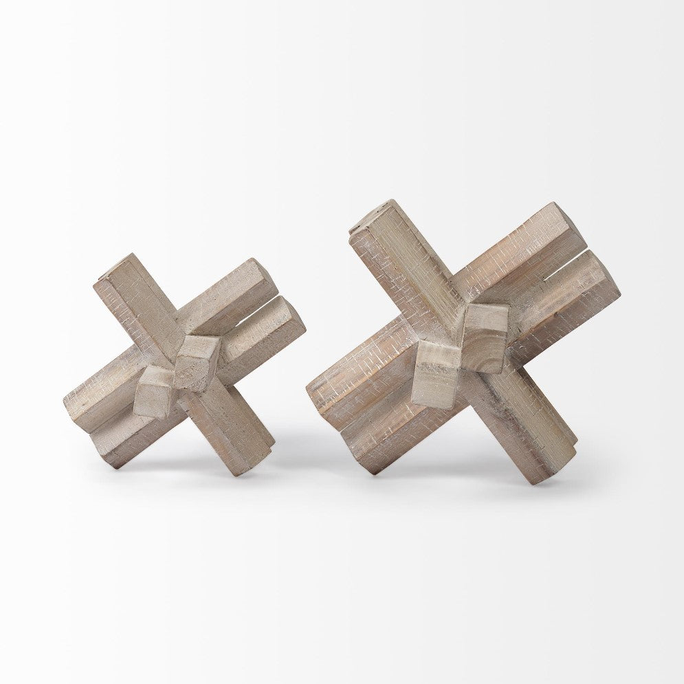 Two wooden 3D cross shapes on a plain background.