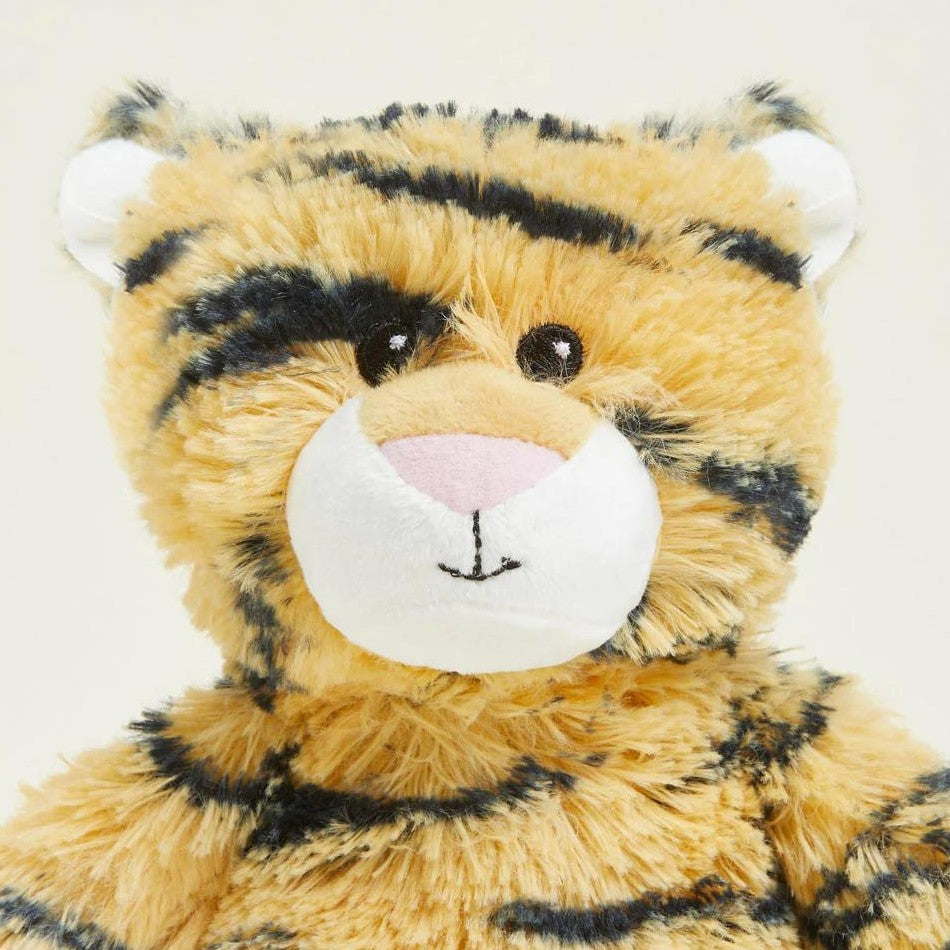 Fluffy tiger-striped stuffed toy with a cute face.