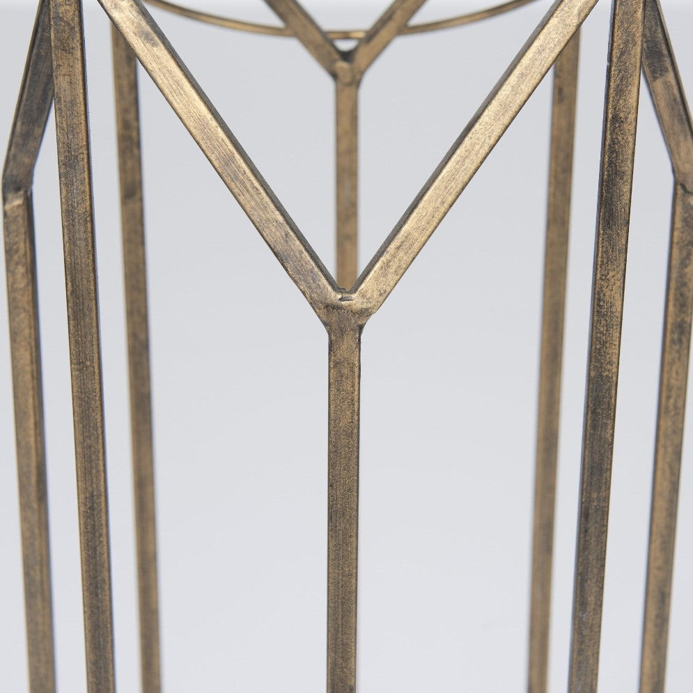 Bronze geometric metal structure on a light background.