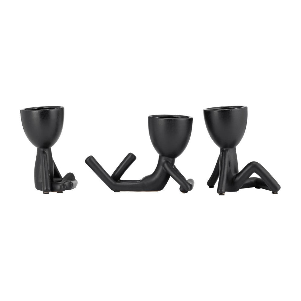 Three black figurine planters in various lounging poses.