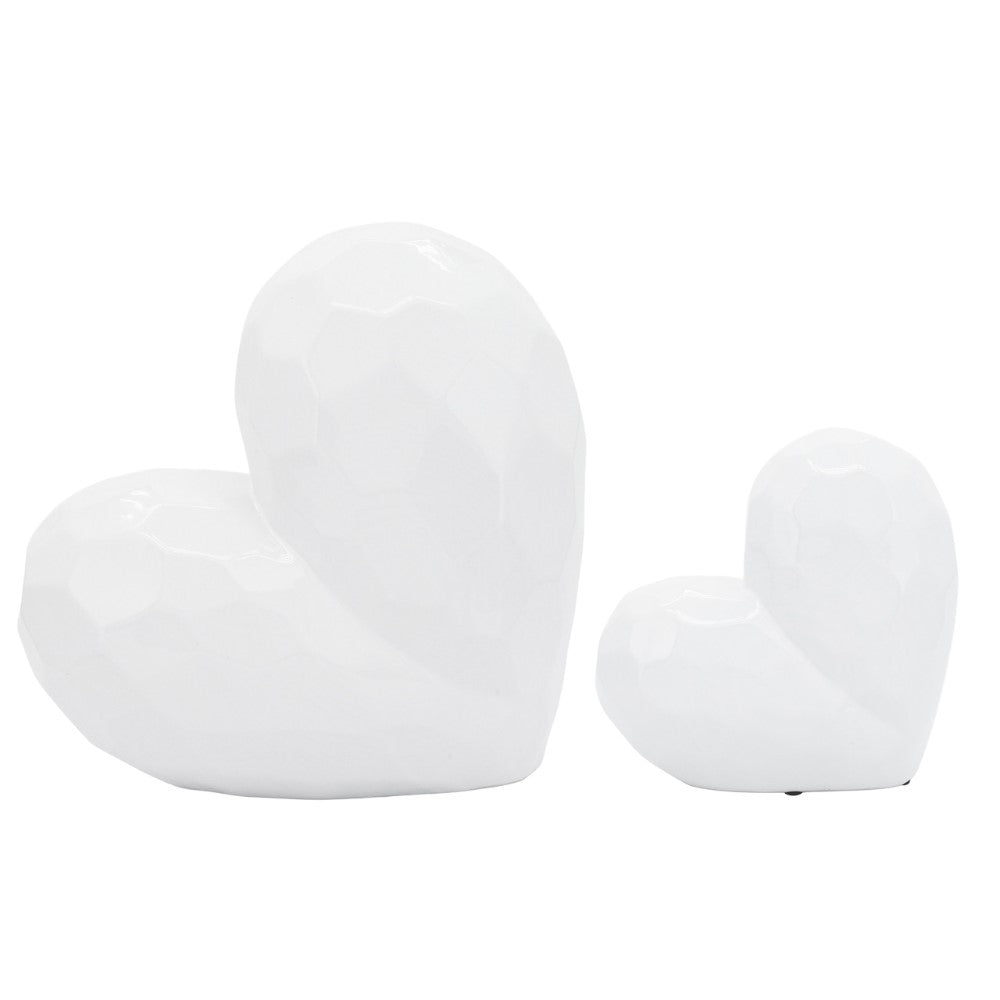 Two white ceramic heart sculptures, large and small.