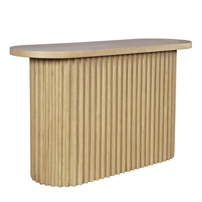 Wooden console table with vertical grooves and round edges.
