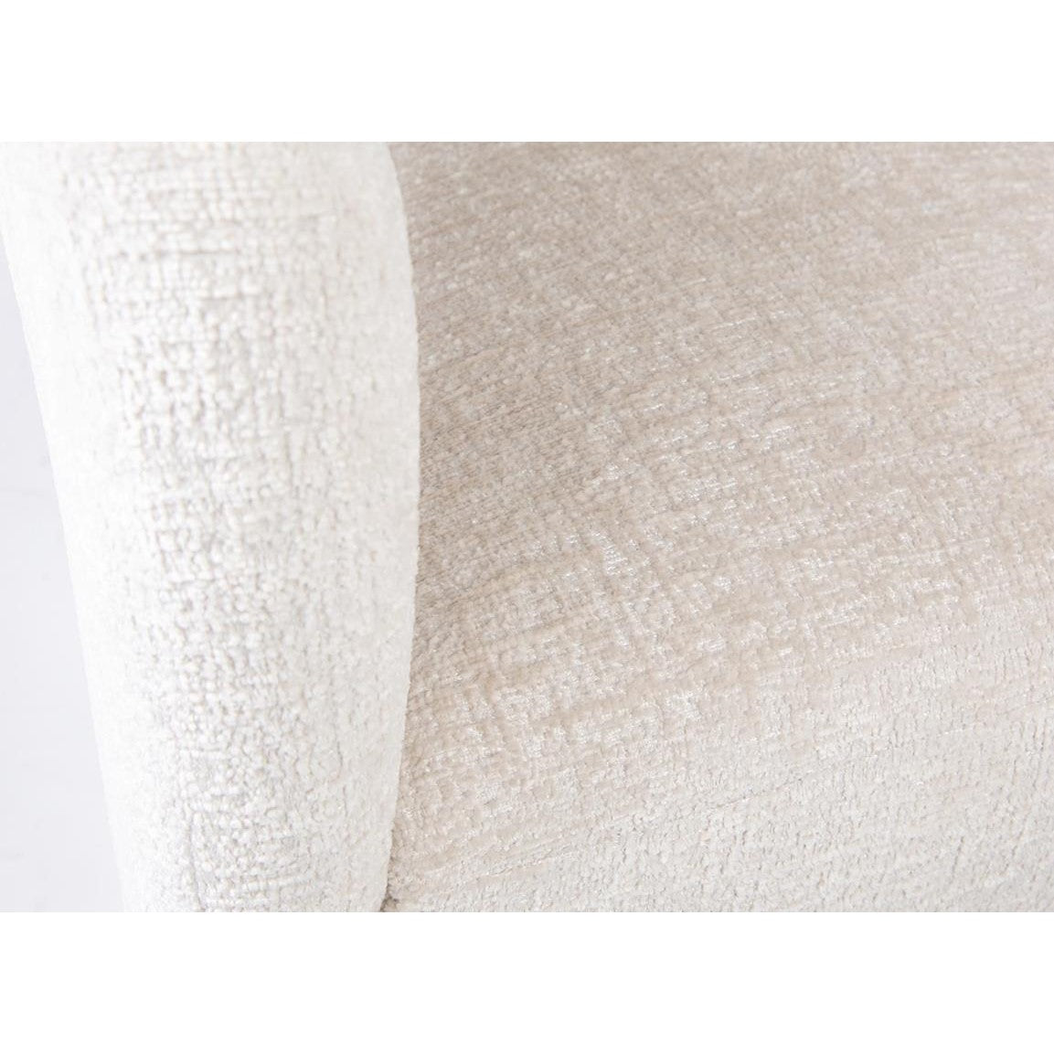 Close-up of textured beige fabric on a cushioned chair arm.