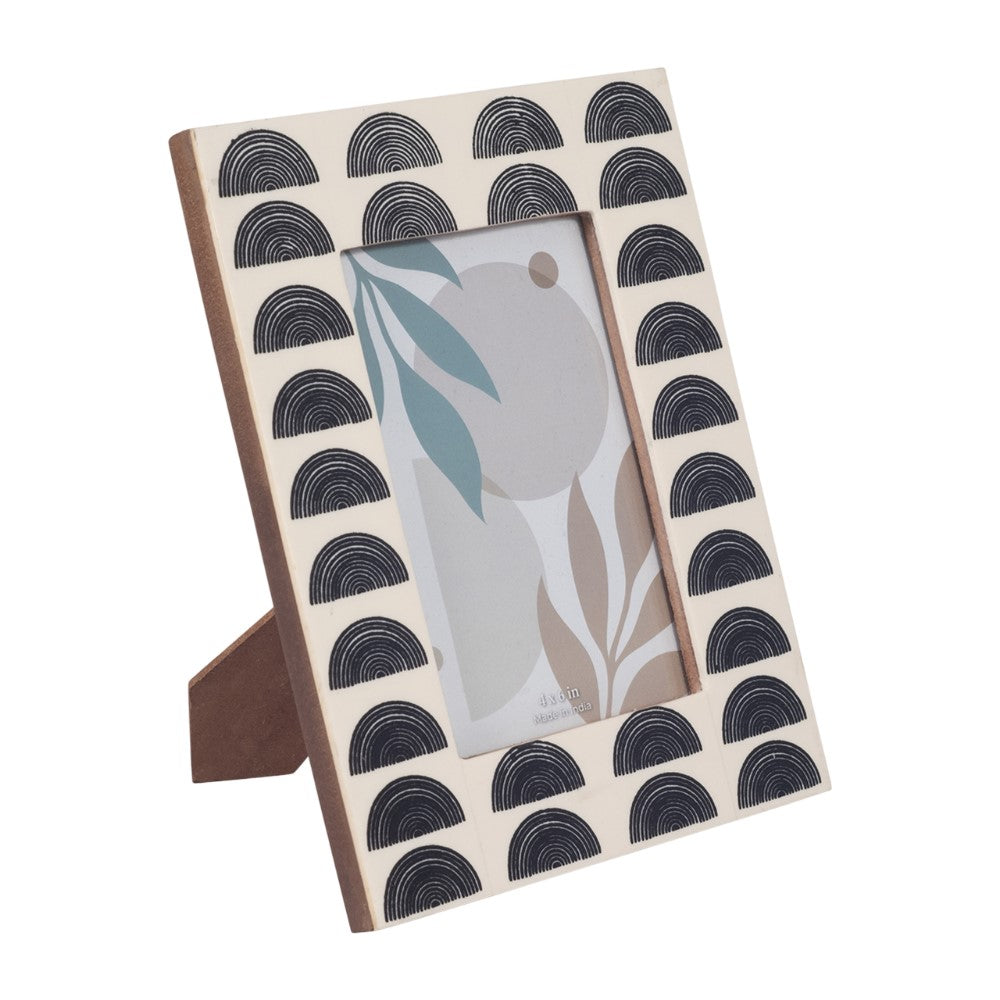 Decorative photo frame with black arch pattern on a white border.