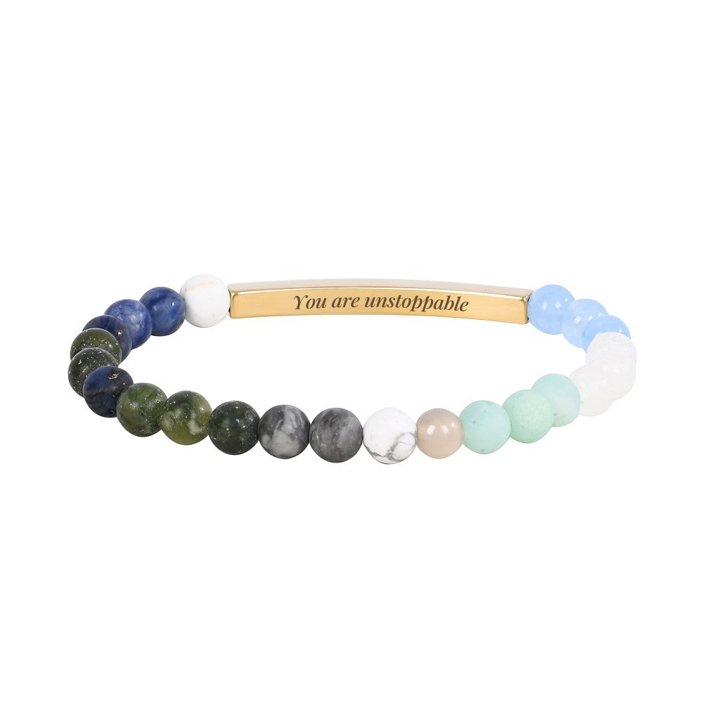 Beaded bracelet with "You are unstoppable" engraved on a gold plate.