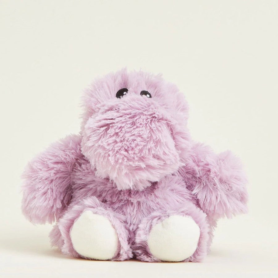 Fluffy purple stuffed animal with black eyes and white feet.
