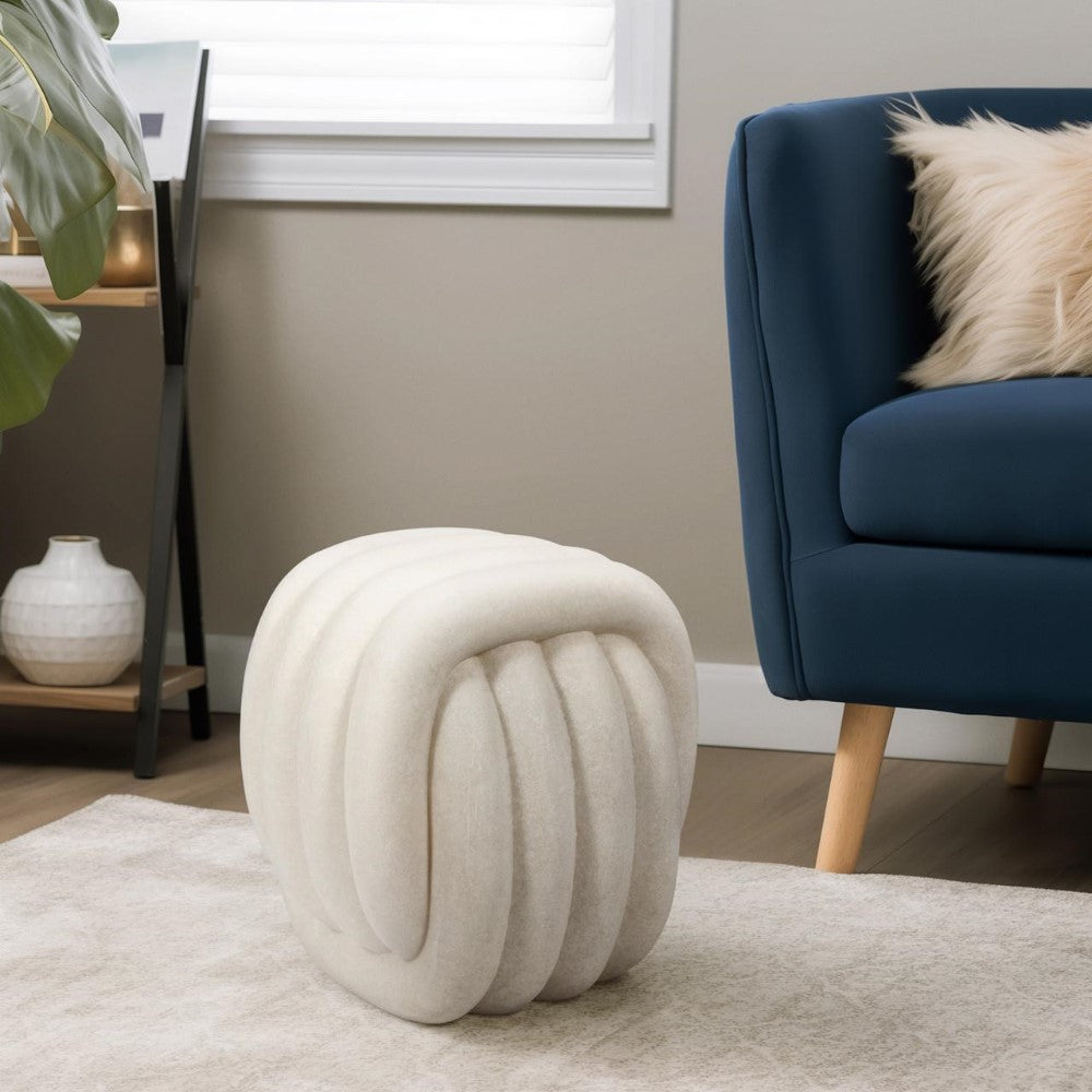 Modern white stool and navy chair in a stylish living room.