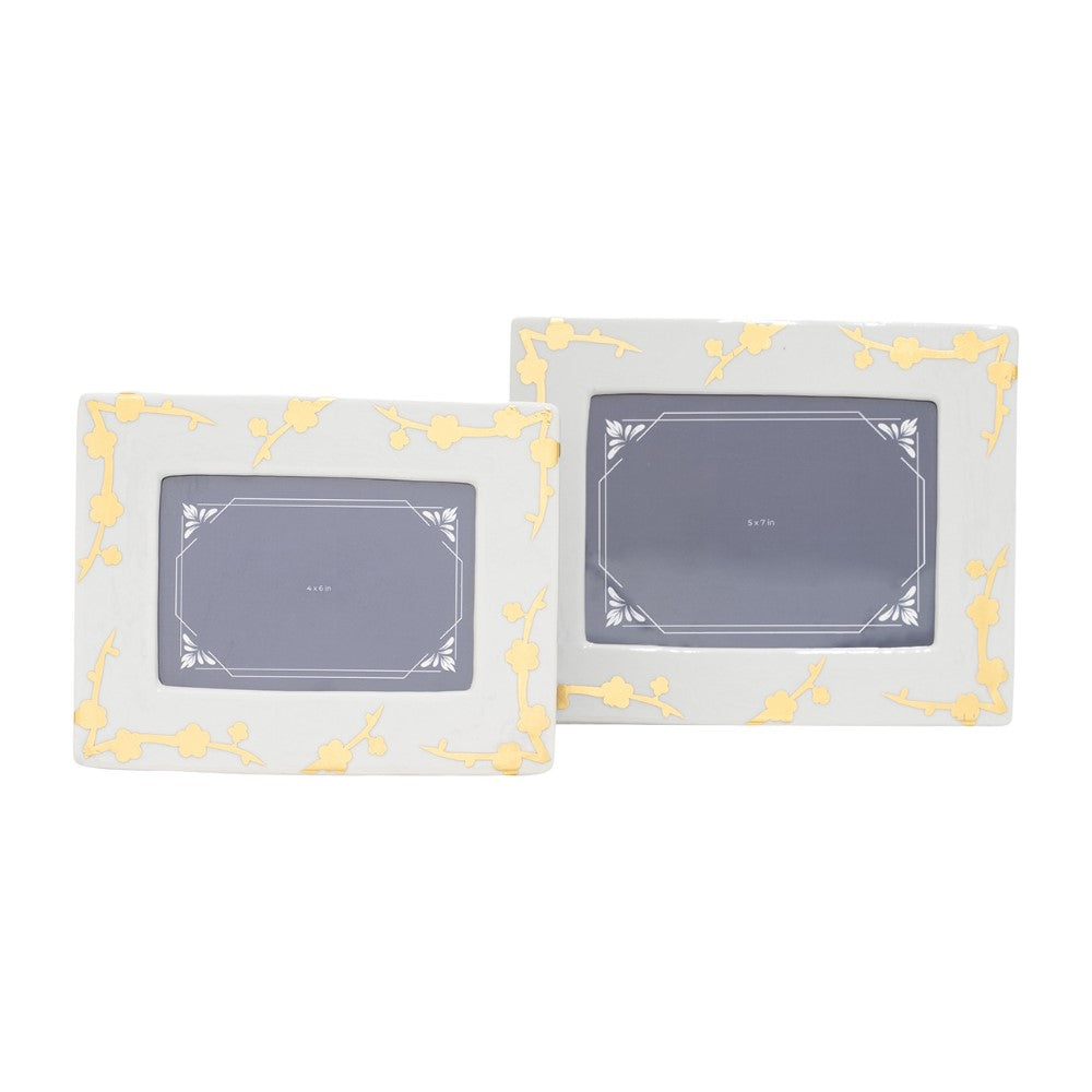 Two decorative photo frames with gold floral patterns.