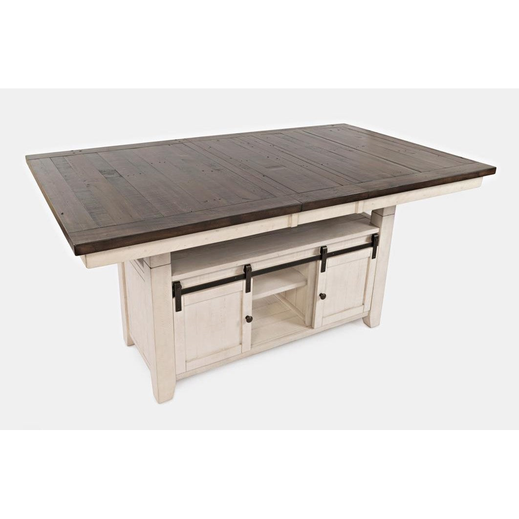 Rustic dining table with dark top and white base, featuring sliding barn doors.