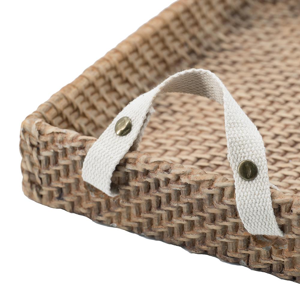 Woven tray with white cloth handles and metal studs.