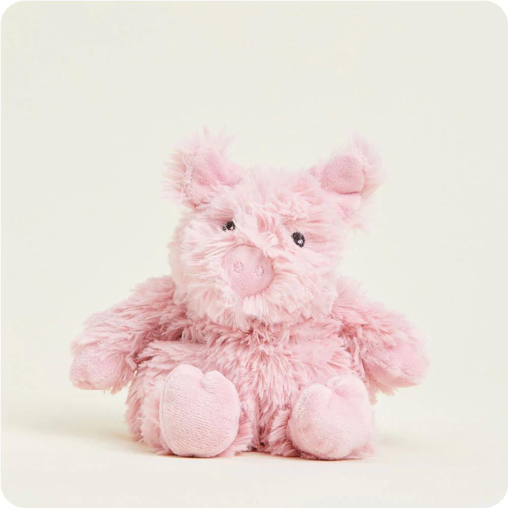Fluffy pink pig plush toy sitting upright.