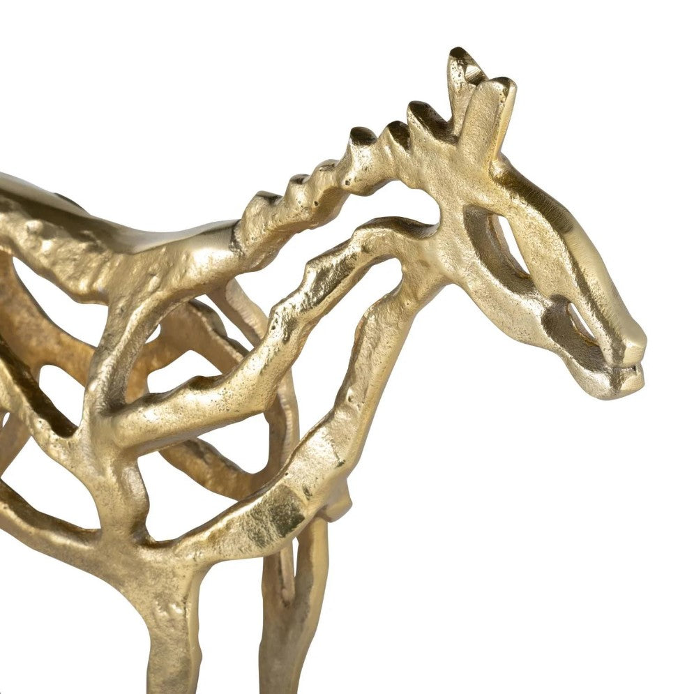 Abstract gold horse sculpture with a skeletal design.