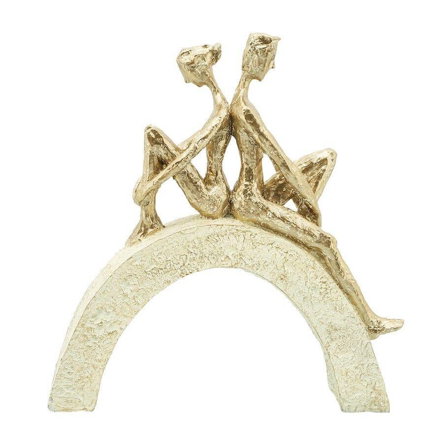 Two golden abstract figures sitting back-to-back on an arch.