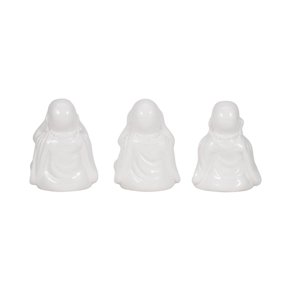 Three white ceramic figurines with minimalist features.