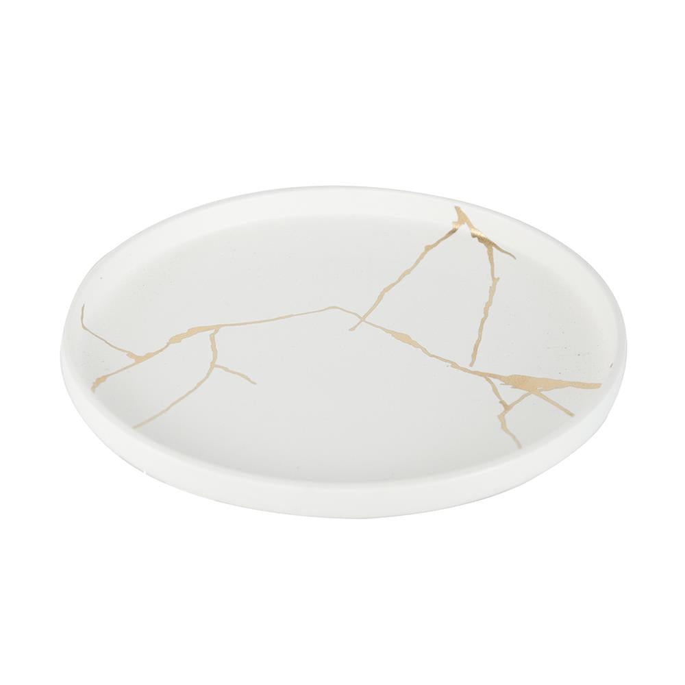 White plate with a gold crack-like pattern, minimalist design.