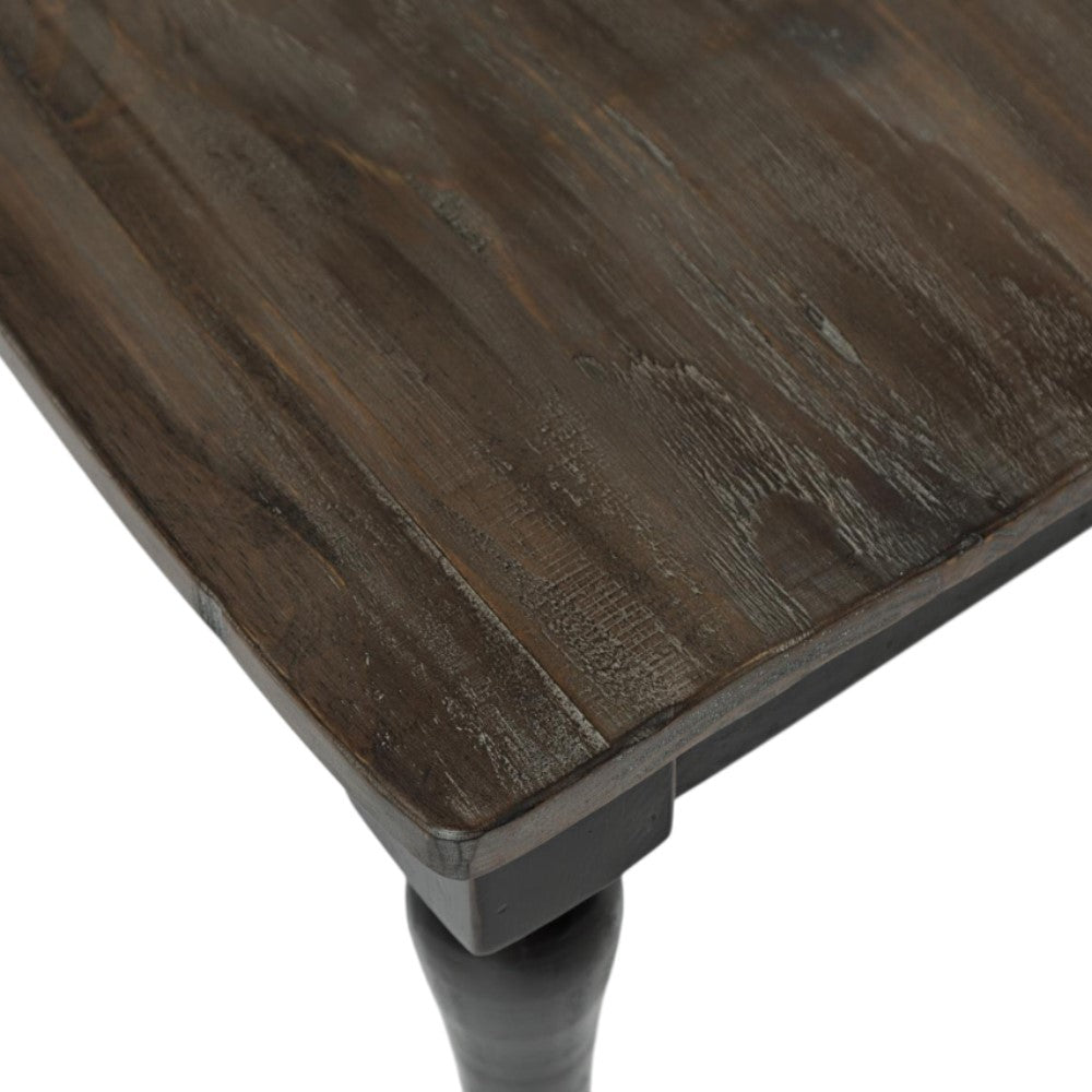 Dark wooden table corner with a textured surface.