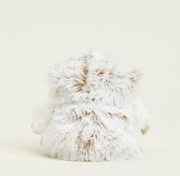 Fluffy, white owl plush toy facing backward.
