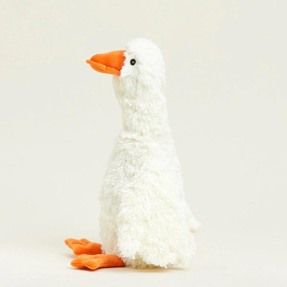 Fluffy white toy goose with orange beak and feet standing upright.
