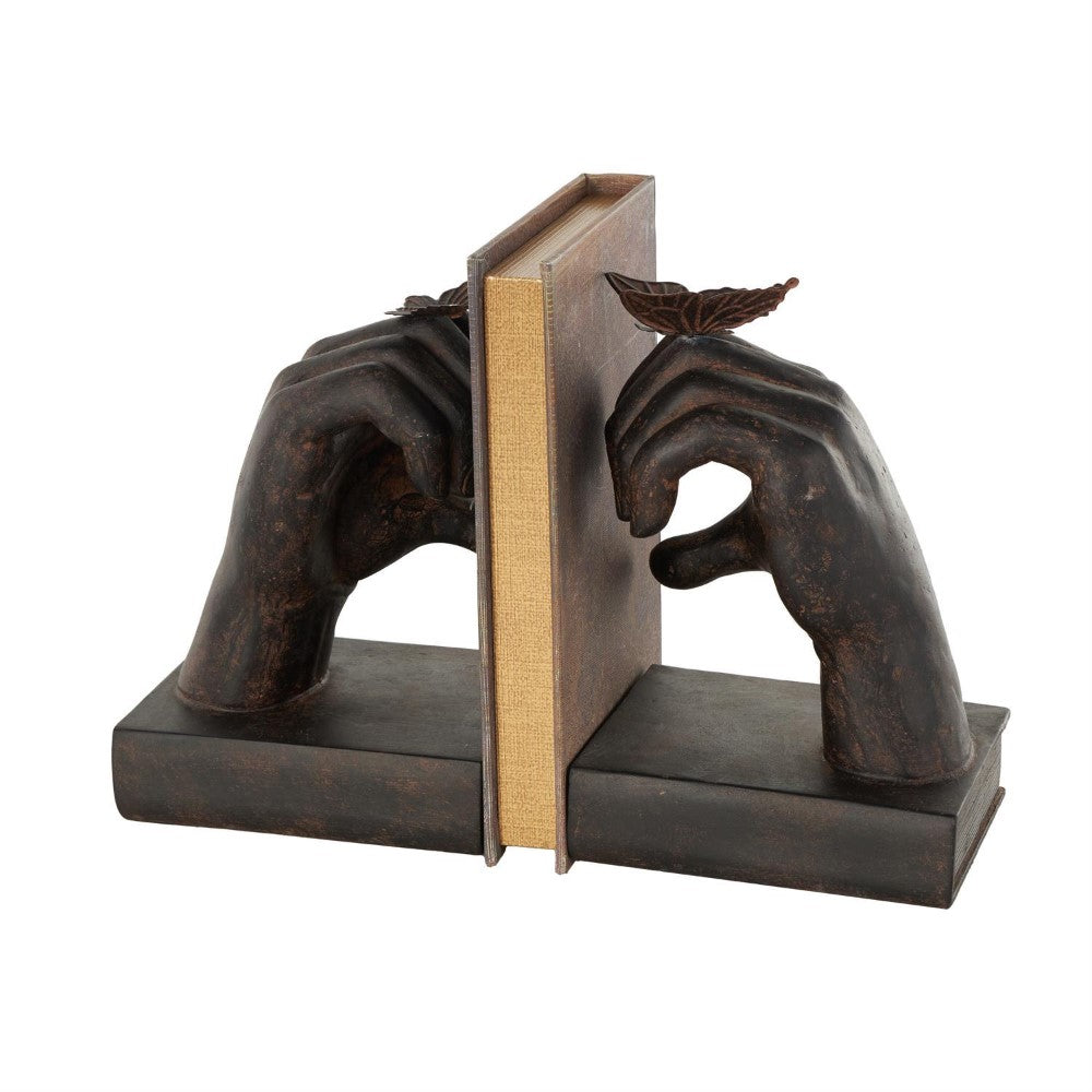 Sculpted hands hold a book with butterflies on fingers as bookends.