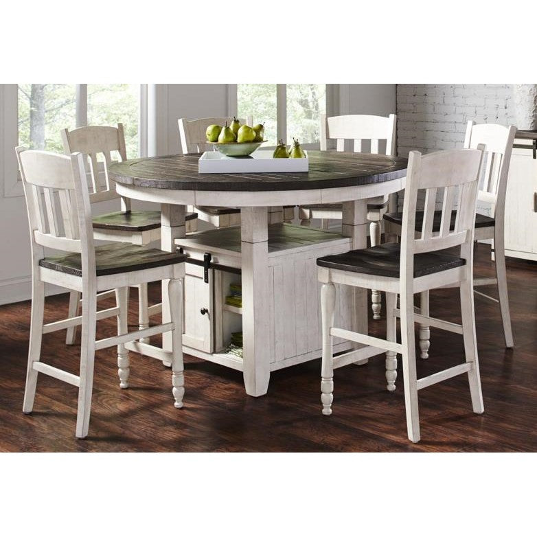 Rustic dining set with white chairs and a dark round table, decorated with green pears.