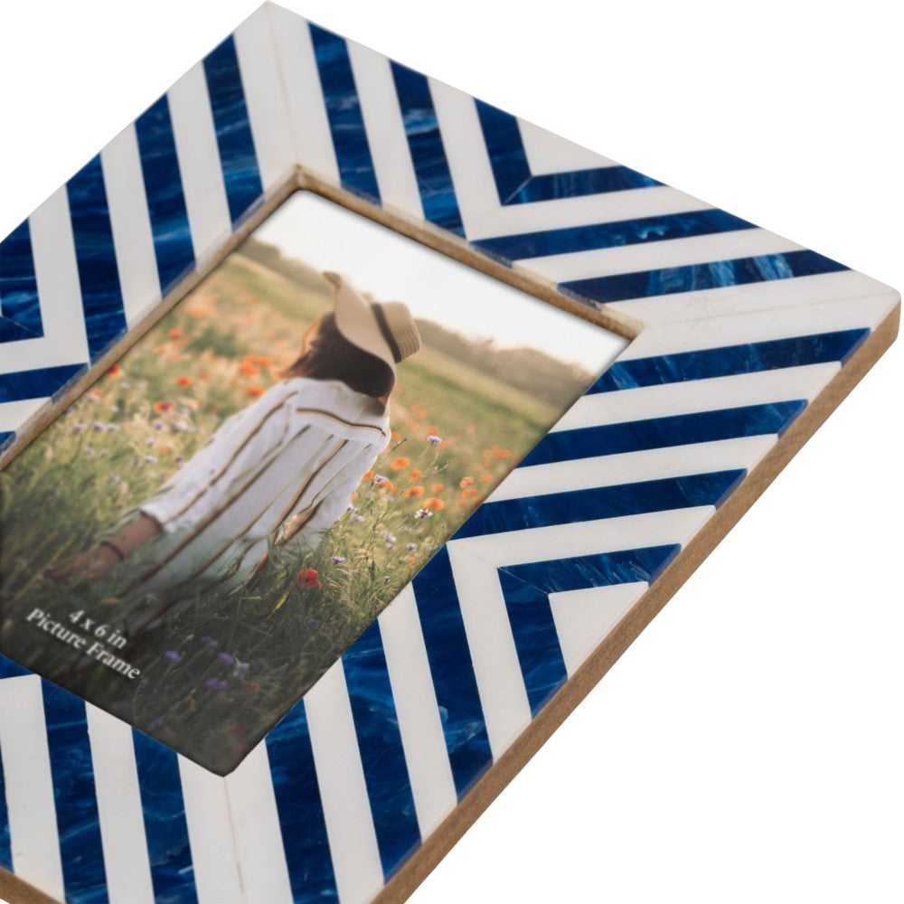 Striped blue and white frame with a photo of a person in a field.