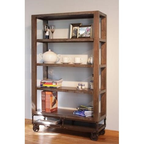Wooden shelf with decor, books, and kitchenware on wheels.