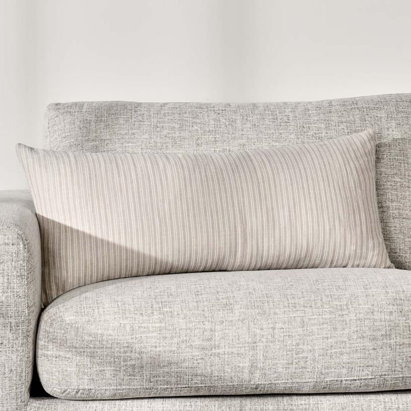 Gray sofa with a striped pillow on it.