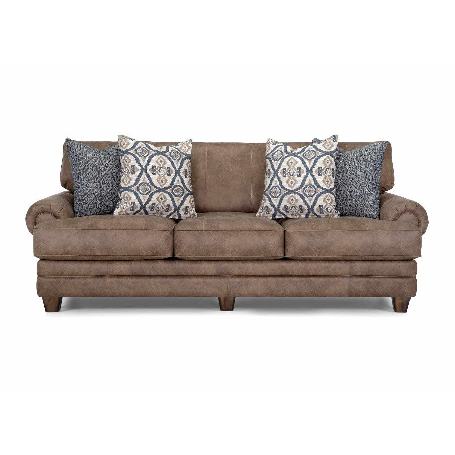 Brown sofa with blue pillows featuring patterned designs.
