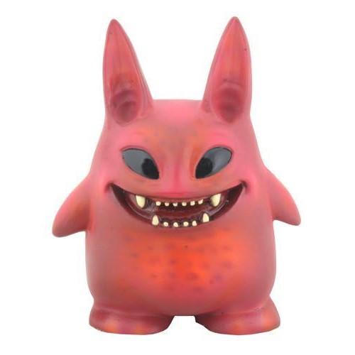 Pink creature with big ears, sharp teeth, and a broad grin.