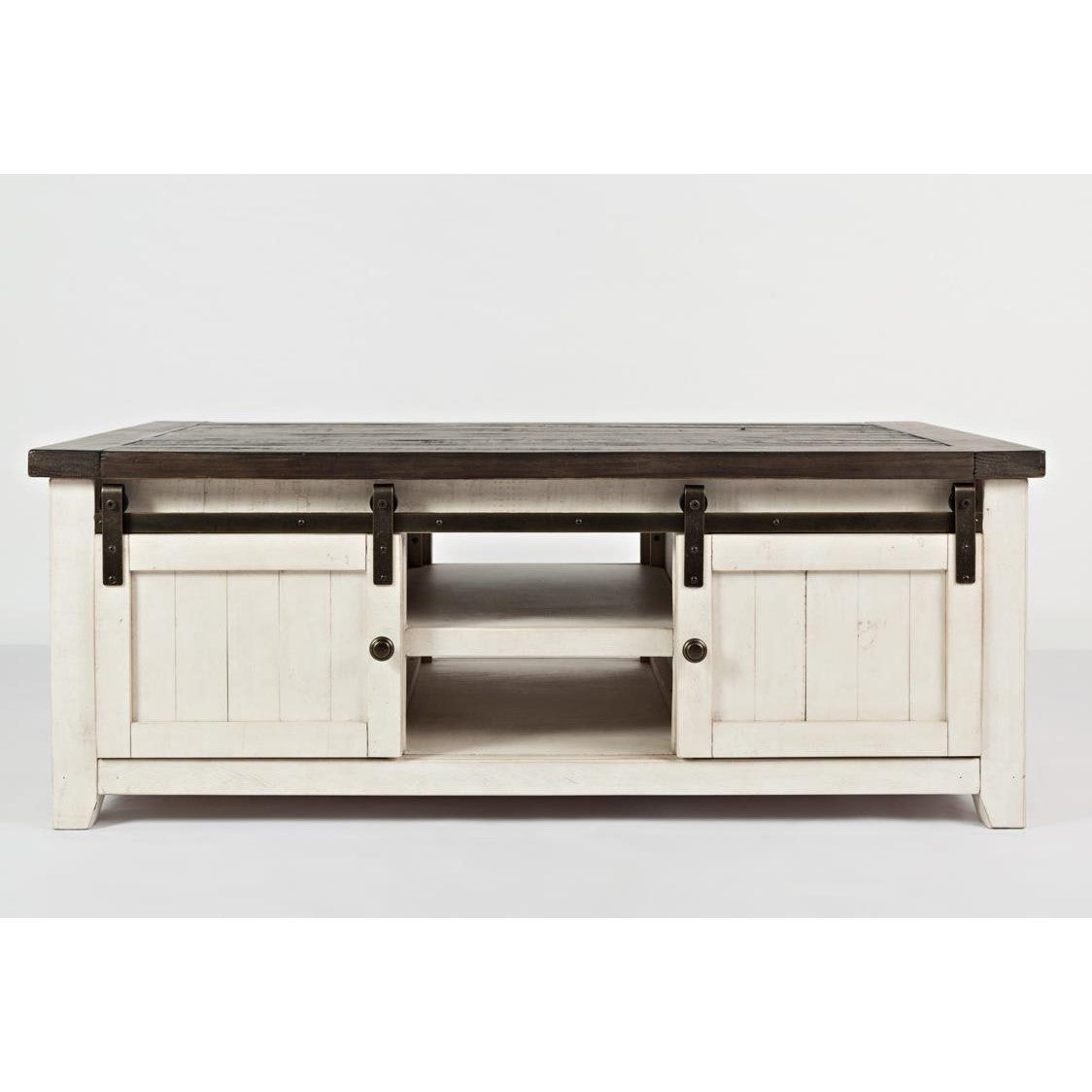 Rustic white coffee table with sliding barn doors and dark top.