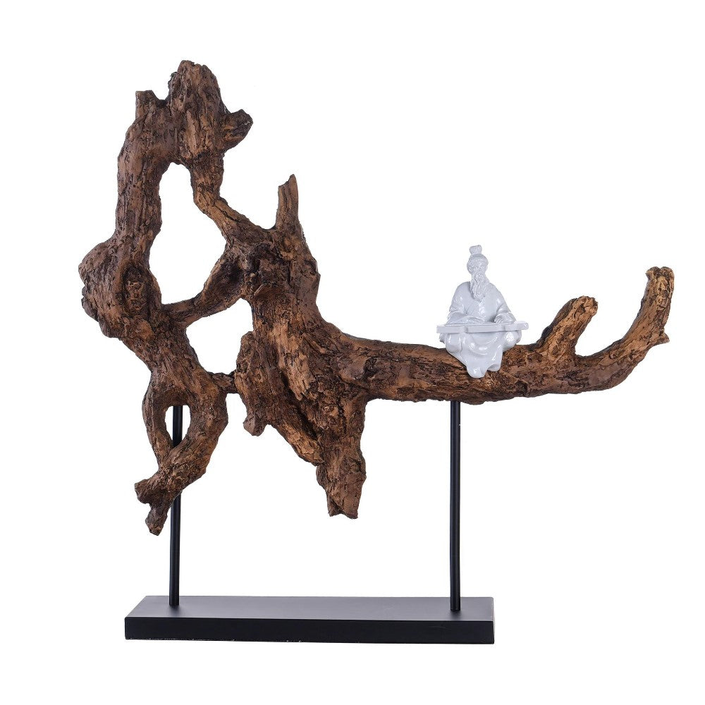 Wooden sculpture with a small white figurine sitting on a branch.