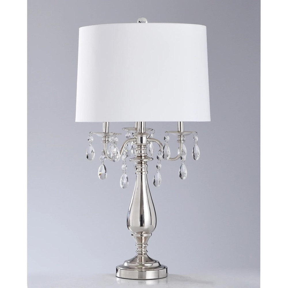 Elegant metal lamp with white shade and crystal accents.