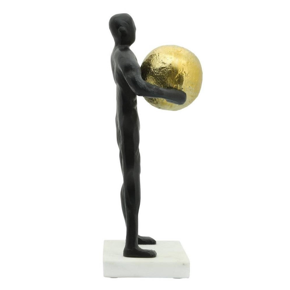 Black sculpture holding a gold globe on a white base.
