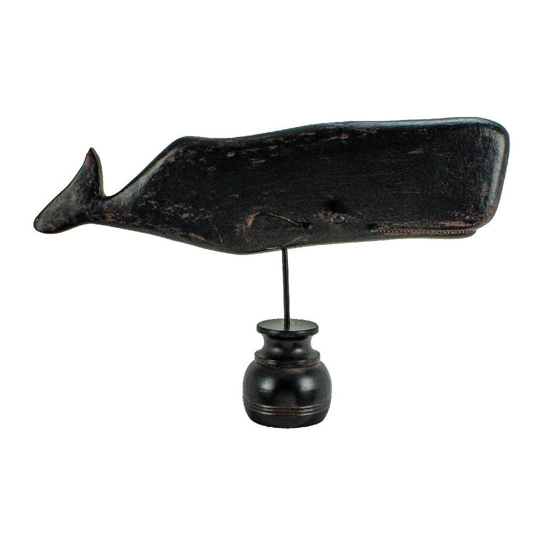 Rustic whale sculpture on a small pedestal stand.