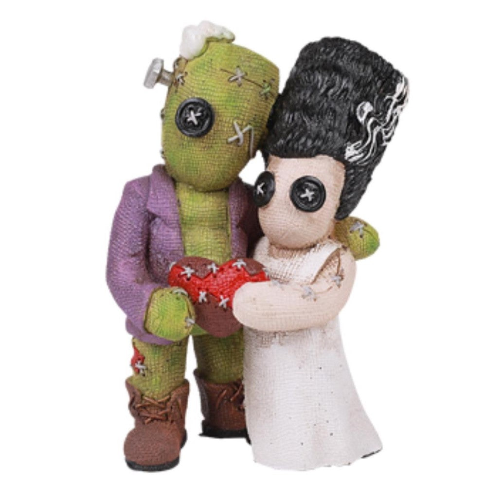 Cute plush couple holding a stitched red heart.