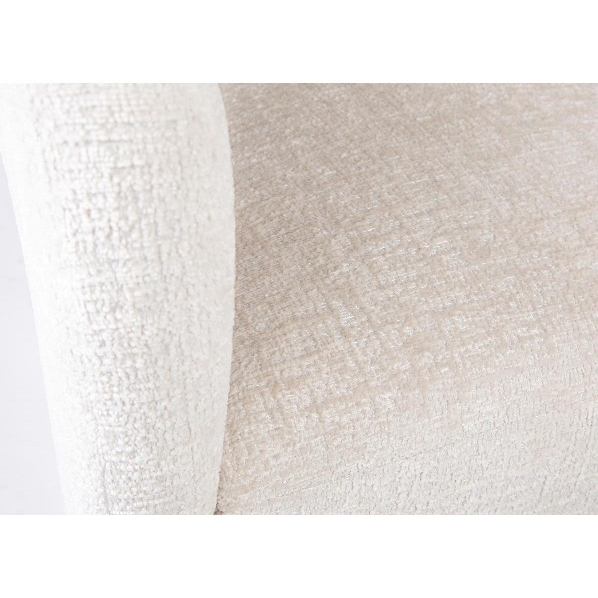 Close-up of a beige textured fabric on a curved armrest.