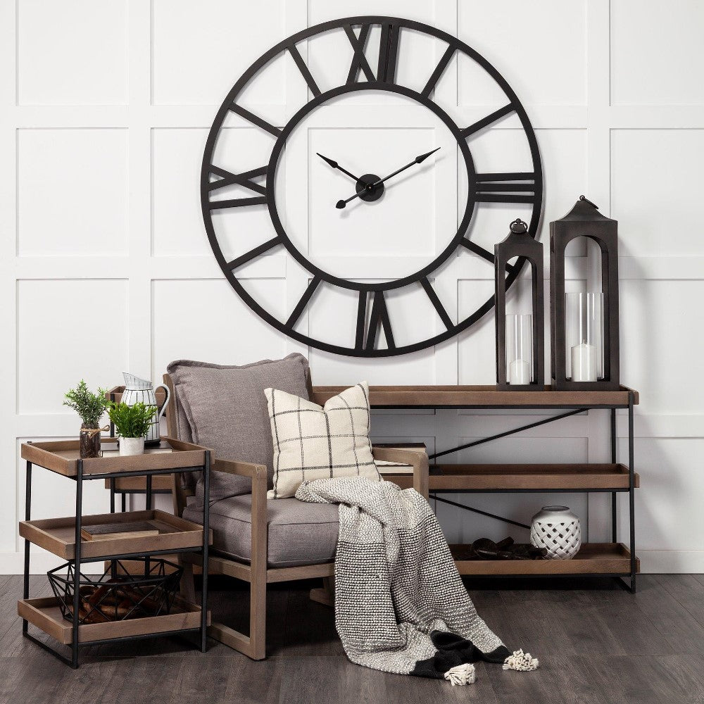 Cozy modern room with large clock, chair, and wooden shelves.