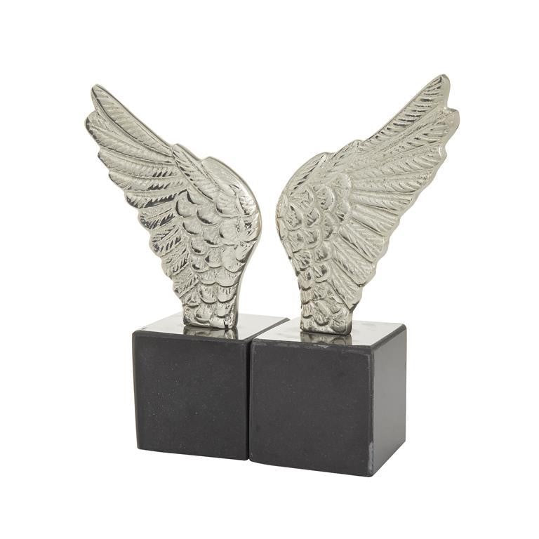 Silver wing sculptures on black cube bases.