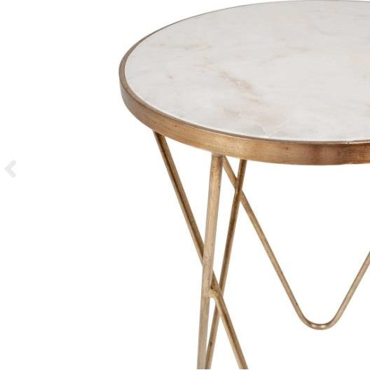 Round marble-topped table with gold metal legs.