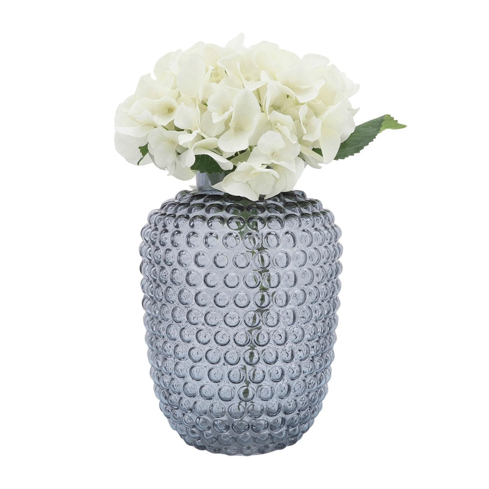 White hydrangeas in a textured glass vase.
